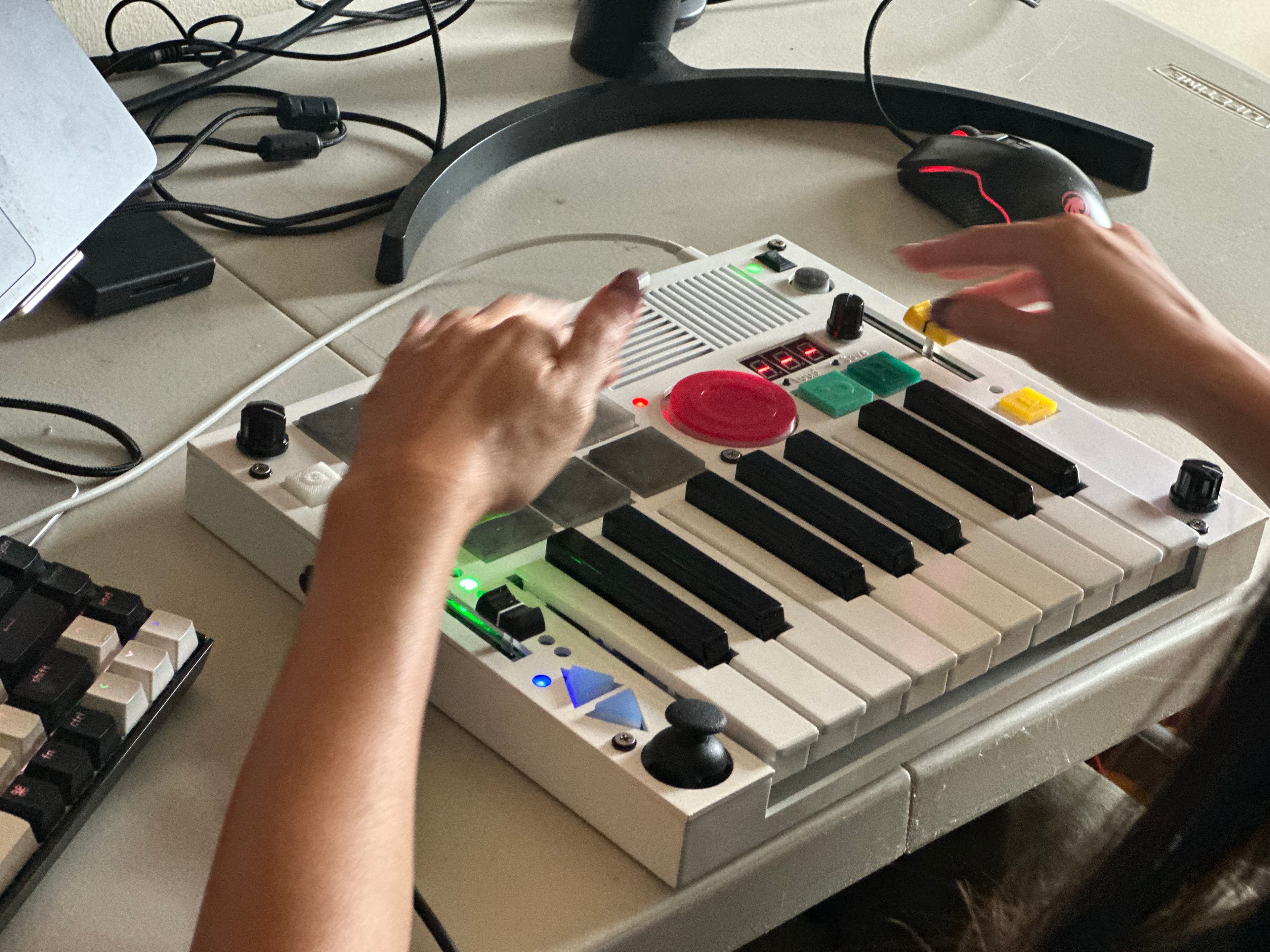 Hands playing a white Beat Brick on a desk