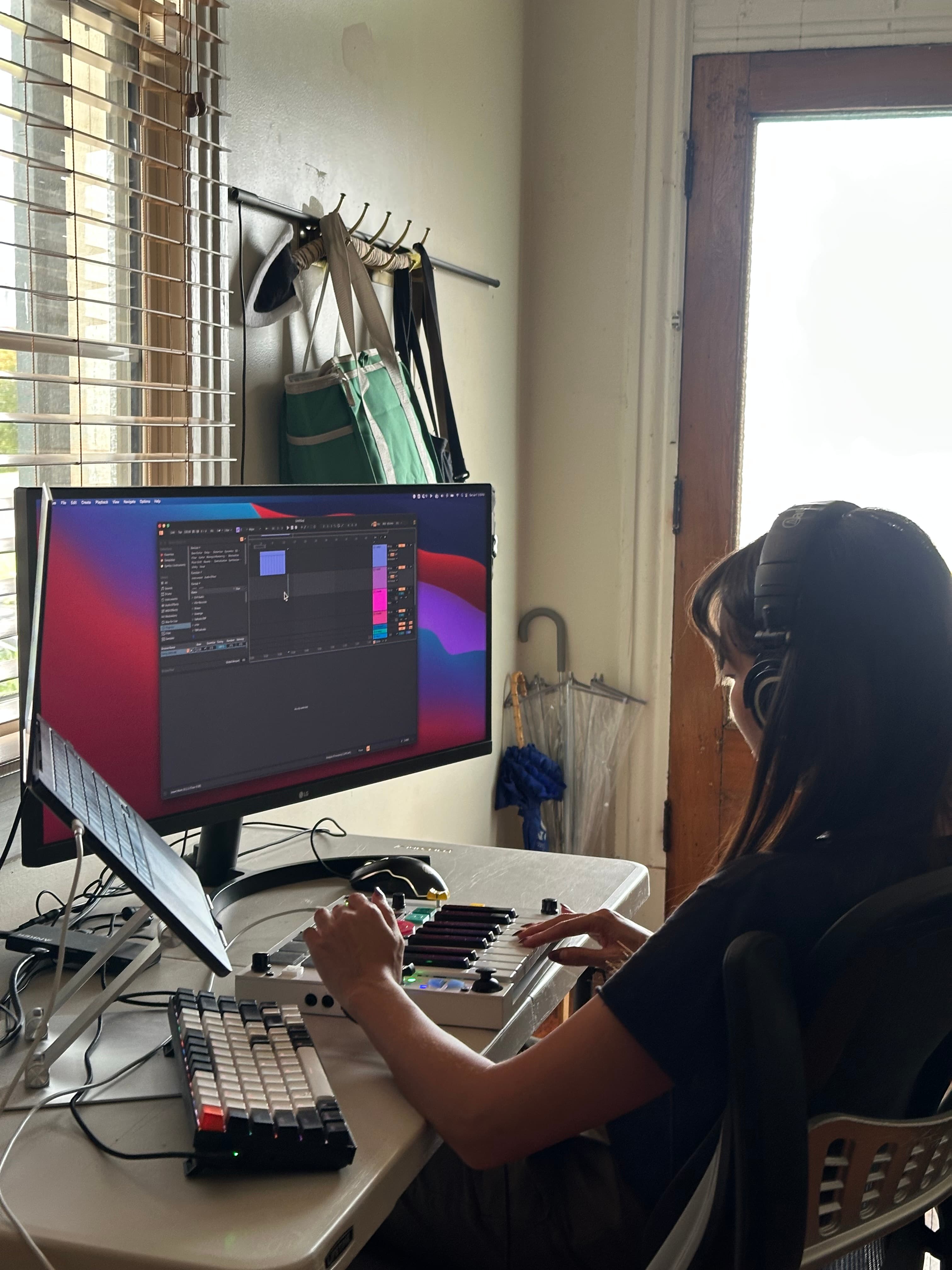 Playing The Beat Brick at a desk with headphones and a monitor